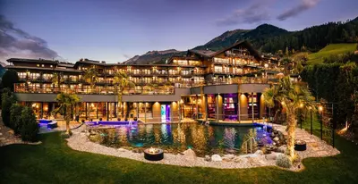 a hotel with a pool in front of a building at Andreus Resorts in San Leonardo in Passiria