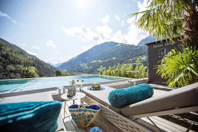 a balcony with a view of a lake and mountains at Andreus Resorts in San Leonardo in Passiria