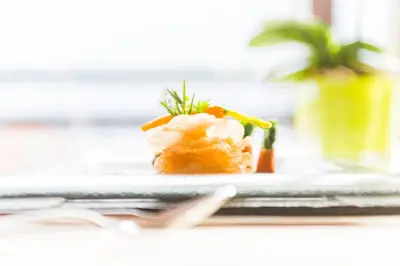 a plate of food with shrimp on a table at Hotel Sonnenalm in Saltusio