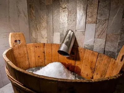 a bucket filled with snow with a water funnel at Mountain Home Villa Anna in Selva di Val Gardena