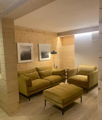 a living room with a couch and two chairs at Mountain Home Villa Anna in Selva di Val Gardena
