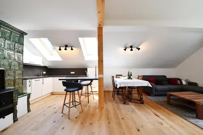 a kitchen and living room with a couch and a table at Castel Campan in Bressanone