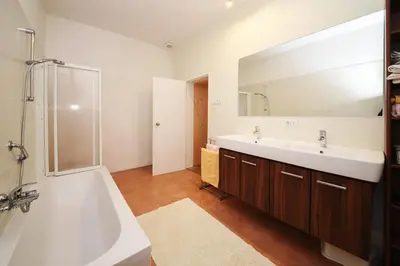 a bathroom with a tub and a sink and a mirror at Castel Campan in Bressanone