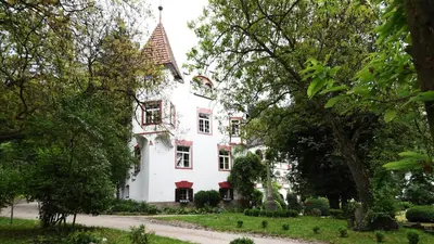 a white house with a red roof at Castel Campan in Bressanone