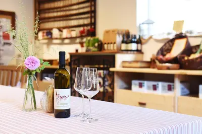 a bottle of wine and two glasses on a table at Castel Campan in Bressanone