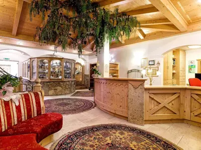 a large room with a bar in a building at Leading Relax Hotel Maria in Moena