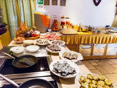 a kitchen with a buffet of food on a counter at Leading Relax Hotel Maria in Moena
