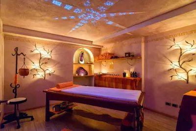 a room with a bed and a ceiling with lights at Leading Relax Hotel Maria in Moena