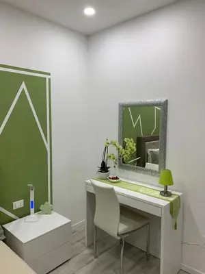 a desk with a mirror and a chair in a room at CEJM Apartments Merano in Merano