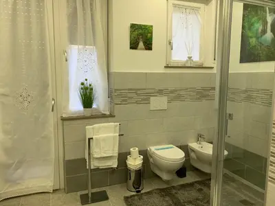 a bathroom with a toilet and a sink at CEJM Apartments Merano in Merano