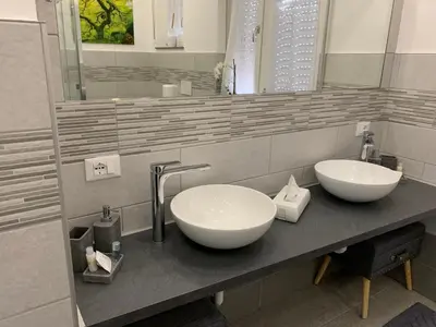 a bathroom with two sinks on a counter at CEJM Apartments Merano in Merano