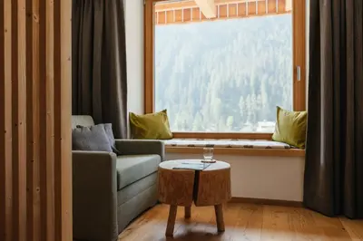 a table with plates of food and drinks on it at Berghotel Sanví in San Martino in Badia