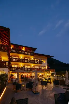 a man and a woman laying in bed at Adults only Hotel Grafenstein in Schenna