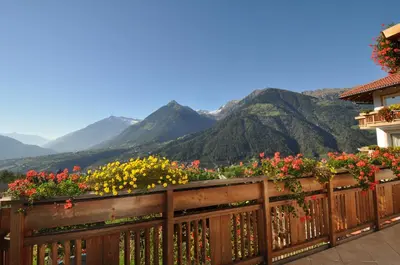 a large house with a swimming pool in the yard at Adults only Hotel Grafenstein in Schenna