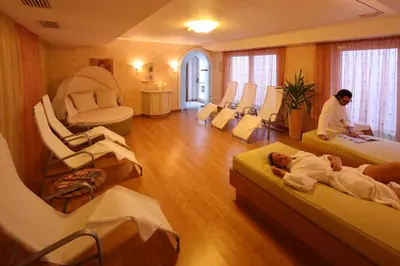 a woman sitting on the inside of a sauna at Adults only Hotel Grafenstein in Schenna