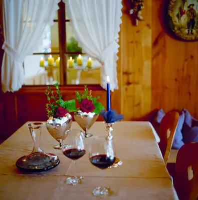 a dining room with two tables with yellow table cloth at Adults only Hotel Grafenstein in Schenna