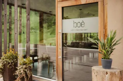 a door to a building with a sign on it at Hotel Boè Sport and Nature in Arabba
