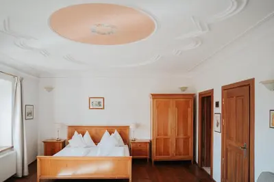 a bedroom with a bed and a ceiling at Ansitz Gurtenhof in Tesimo