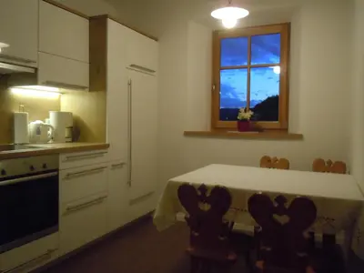 a kitchen with a table and a window at Feldererhof in Siusi