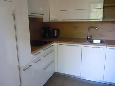 a kitchen with white cabinets and a sink at Feldererhof in Siusi