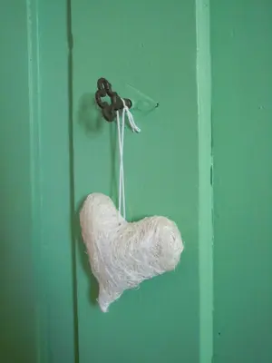 a yarn hanging on a green door at Feldererhof in Siusi