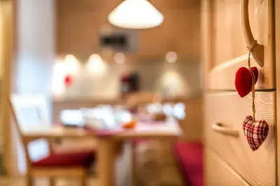 a kitchen with a refrigerator with hearts on it at Appartamenti Maierhof in La Valle