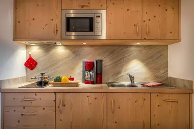 a kitchen with a sink and a microwave at Appartamenti Maierhof in La Valle