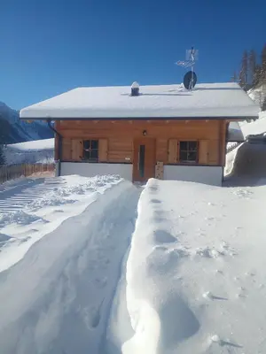 a house covered in snow with a snow path at Chalet Niederhaushof in Ultimo