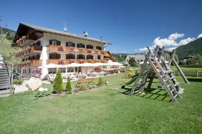 a large building with a playground in front of it at Gasthof Huber in Braies