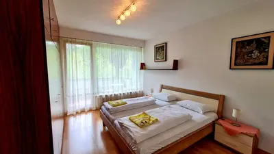 a bedroom with two beds and a window at Residence Atlantic in Merano