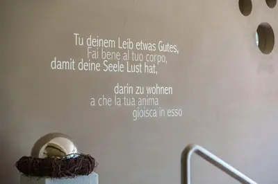 a wall with a quote on it with a wall at Taushof in Schenna