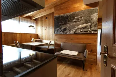 a bedroom with two beds and a wooden ceiling at Appartamenti La Munt in Badia