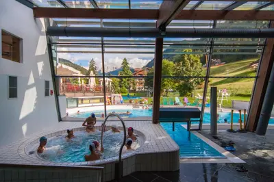 a group of people in a swimming pool at Apartments Dolomie in Ortisei