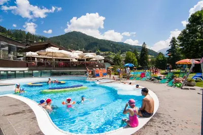 a group of people in a pool at a resort at Apartments Dolomie in Ortisei