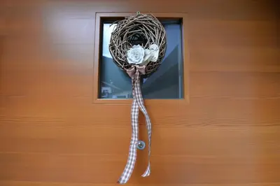 a bird nest with a flower in a window at Apartments Dolomie in Ortisei