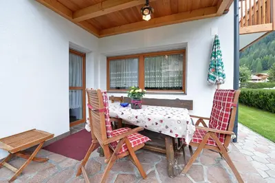 a table and two chairs on a patio at Apartments Dolomie in Ortisei