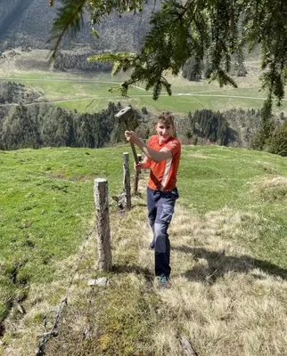a young boy standing on a hill pointing at a bird at Stocknerhof in Bressanone