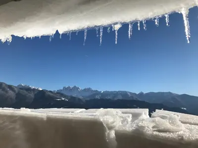 a bunch of icicles hanging off of an iceberg at Stocknerhof in Bressanone
