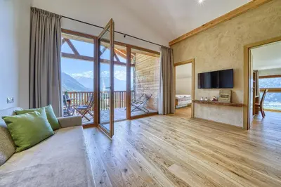 a living room with a couch and a television at Pröfinghof - Urlaub auf dem Biobauernhof in Parcines