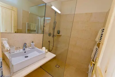a bathroom with a sink and a shower at Hotel Weingut Klosterhof in Caldaro