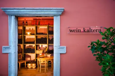 a window of a wine shop with a table in it at Hotel Weingut Klosterhof in Caldaro