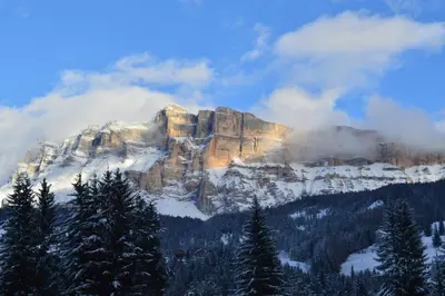 a mountain covered in snow and clouds at Ciasa Andy in Badia