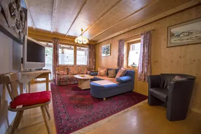 a living room with a couch and a tv at Apartment Soval in Ortisei