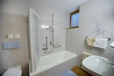 a bathroom with a shower and a tub and a sink at Apartment Soval in Ortisei