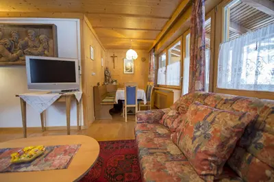 a living room with a couch and a tv at Apartment Soval in Ortisei