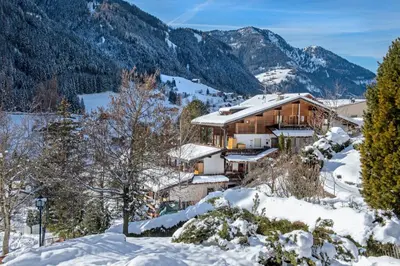 a house in the mountains in the snow at Apartment Soval in Ortisei