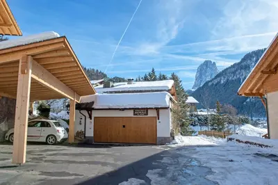 a garage with snow on the roof of a house at Apartment Soval in Ortisei