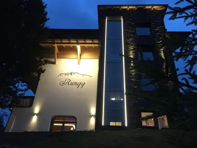 a hotel with cars parked in front of it at Guesthouse Rungg in Badia