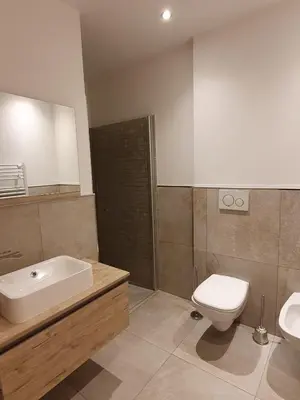 a bathroom with a toilet and a sink and a tub and a toilet at Ciasa De Rosa in Pozza di Fassa