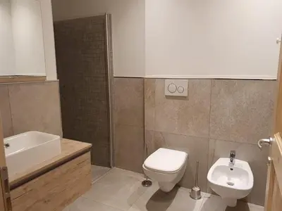 a bathroom with a toilet and a sink at Ciasa De Rosa in Pozza di Fassa